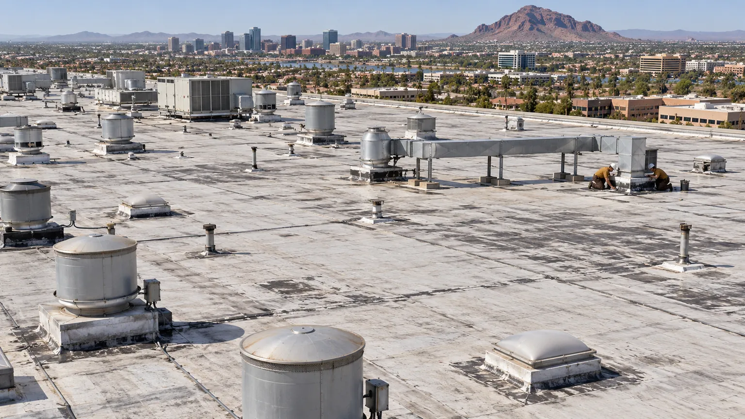 Plant roof crowded with exhaust stacks, fans, and rooftop units